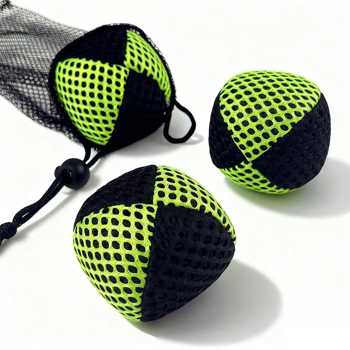 Three black and neon green juggling bean bags with honeycomb mesh pattern, 2.5 inch diameter