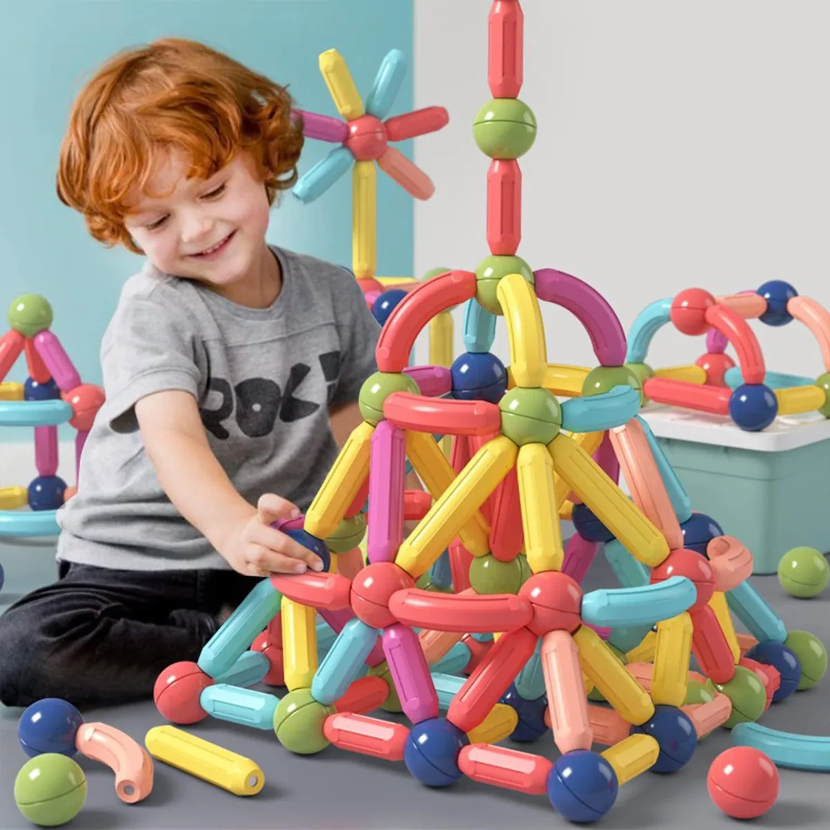 A boxed set of 64 colourful magnetic plastic sticks and balls