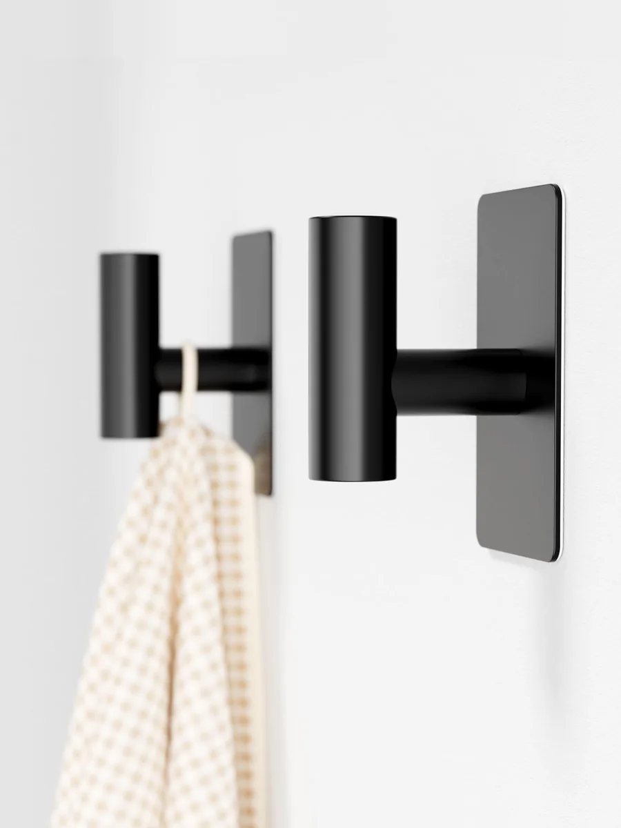 Two matte black stainless steel T-shaped adhesive hooks with wide rectangular bases