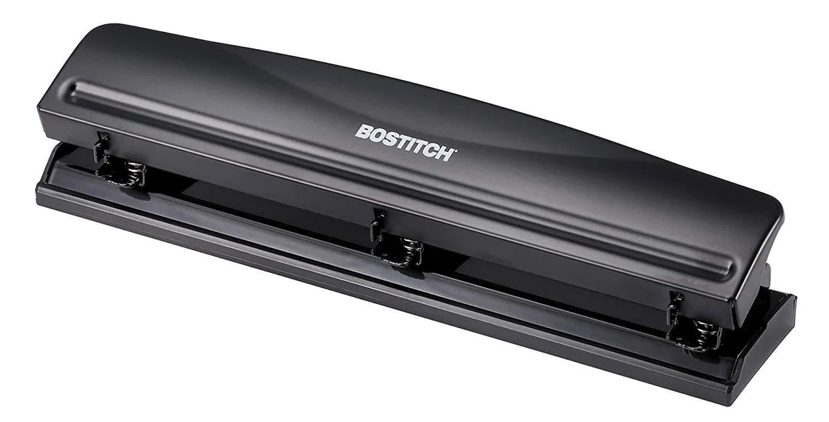 Black metal three-hole punch with rubber base, 12 sheet capacity, chip tray visible