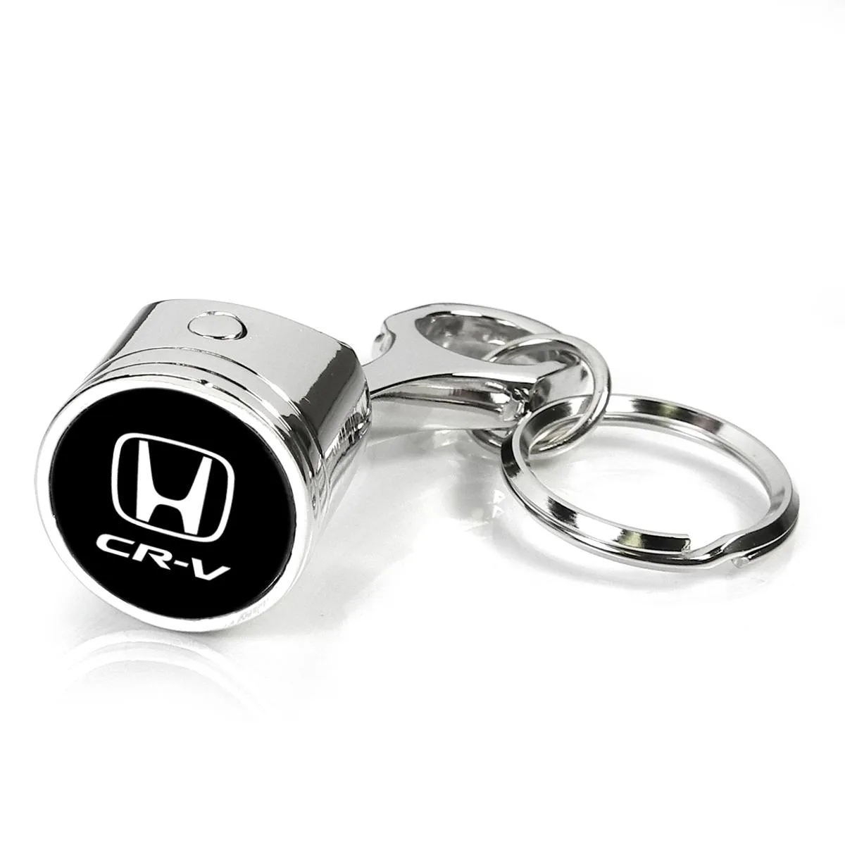 Miniature chrome piston and connecting rod key chain with black Honda CR-V logo under clear dome