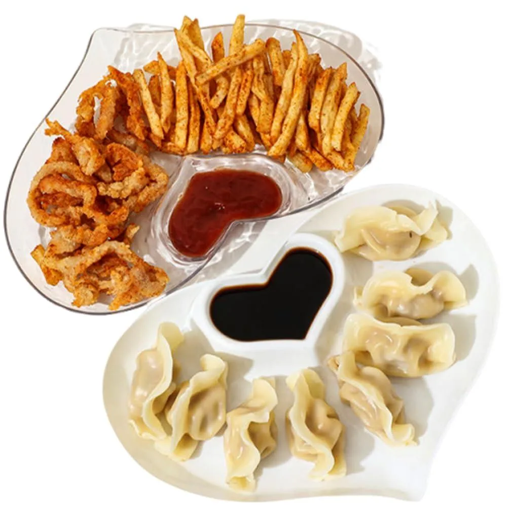Two heart-shaped platters, one white smooth plastic and one transparent rippled plastic, each with a built-in dip compartment