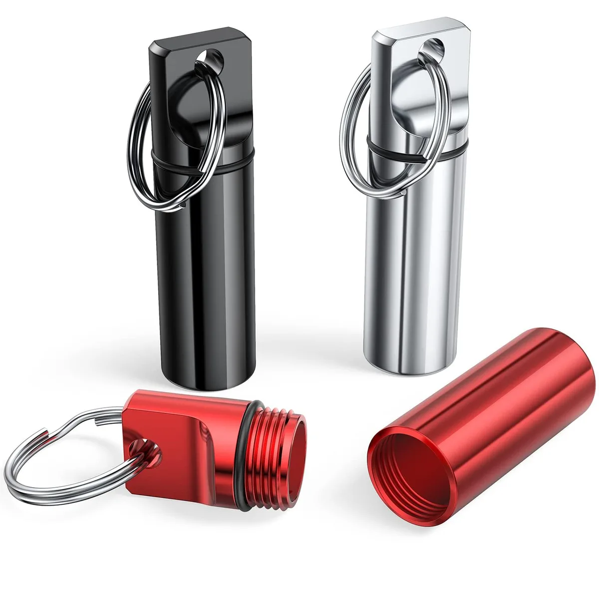 Three small aluminium pill containers on key rings, black silver red