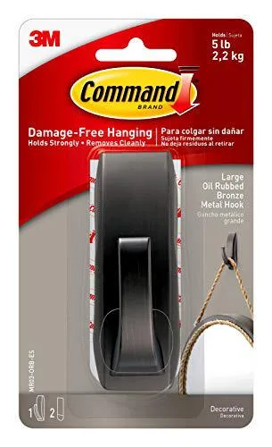 A large metal hook in oil-rubbed bronze finish with two adhesive strips