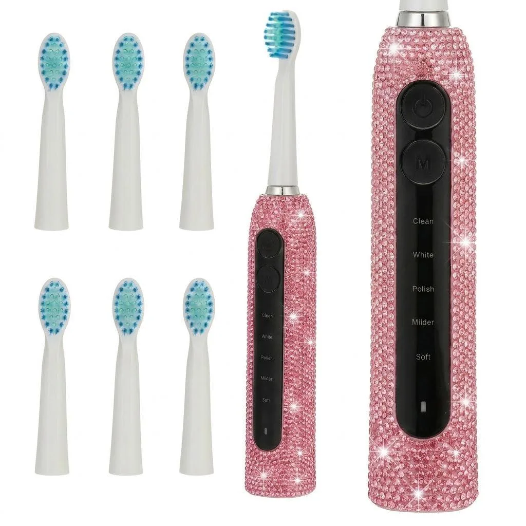 Pink electric toothbrush with glitter finish and diamond studs, includes six brush heads