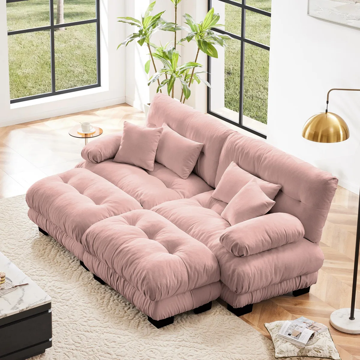 Pink chenille two-seater sleeper sofa with wide bolster arms, two ottomans, lumbar and throw pillows