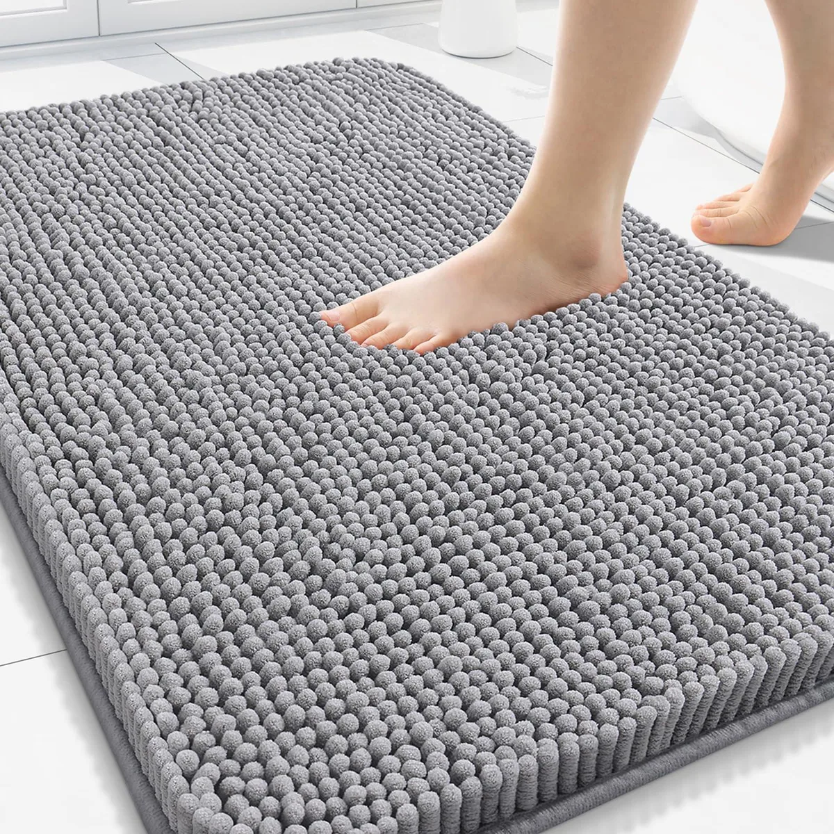 Grey rectangular chenille bath rug, 30 by 20 inches, shaggy pile with rubber backing