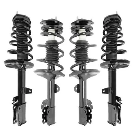 Cardboard box containing four silver strut assemblies with black springs and mounts