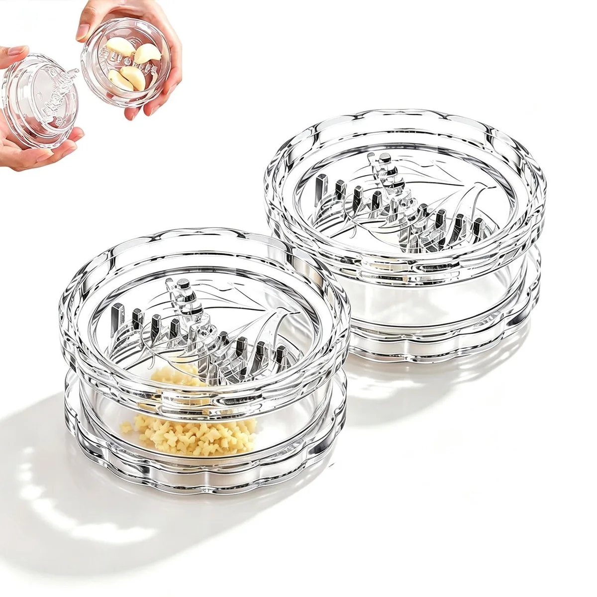 Two clear plastic garlic twister mincers with interlocking teeth, compact cylindrical shape