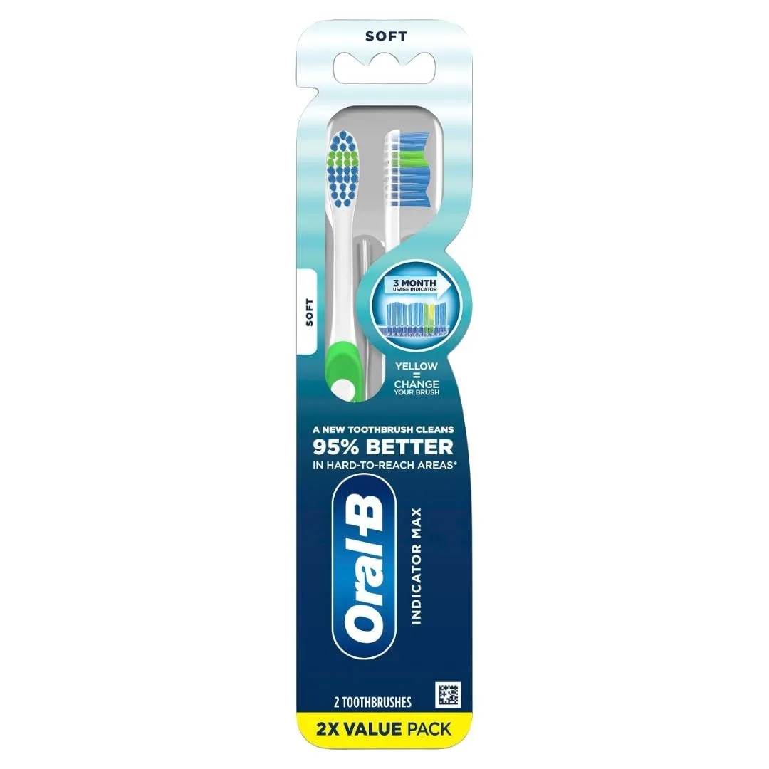 Two blue soft manual toothbrushes with indicator bristles