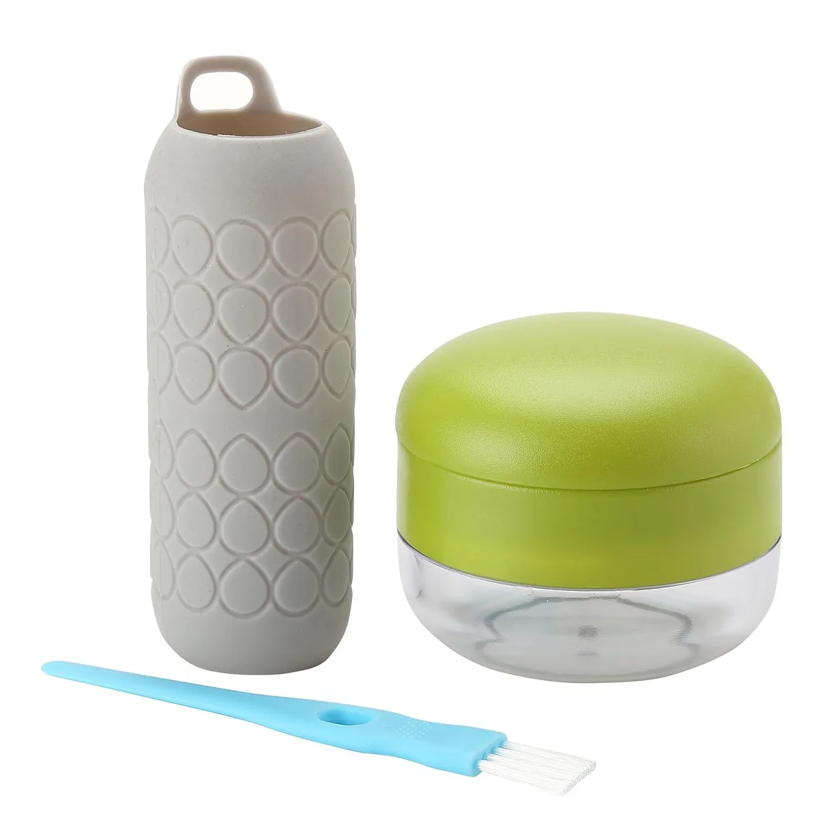 Gray garlic press with textured heart pattern, clear container with green lid, blue cleaning brush, blue silicone peeler tube