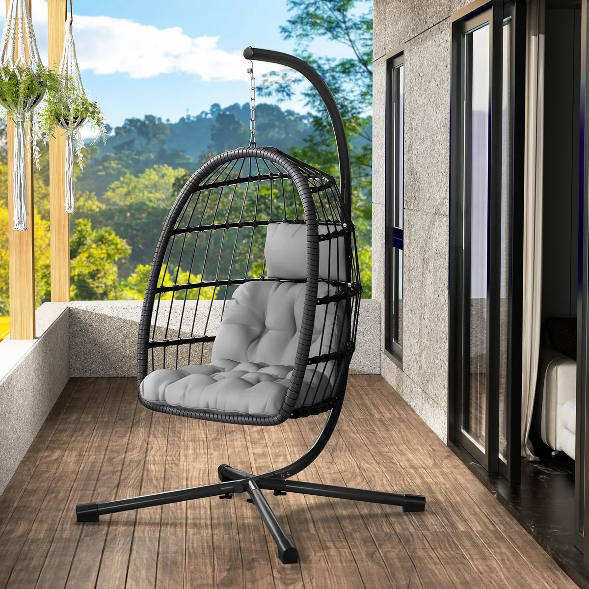 Oversized egg-shaped hanging chair on metal stand with thick cushion