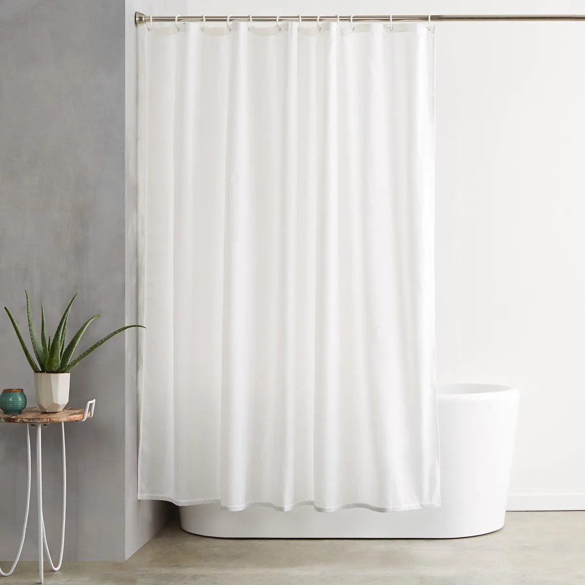 White fabric shower curtain with weighted hem and 12 white plastic hooks