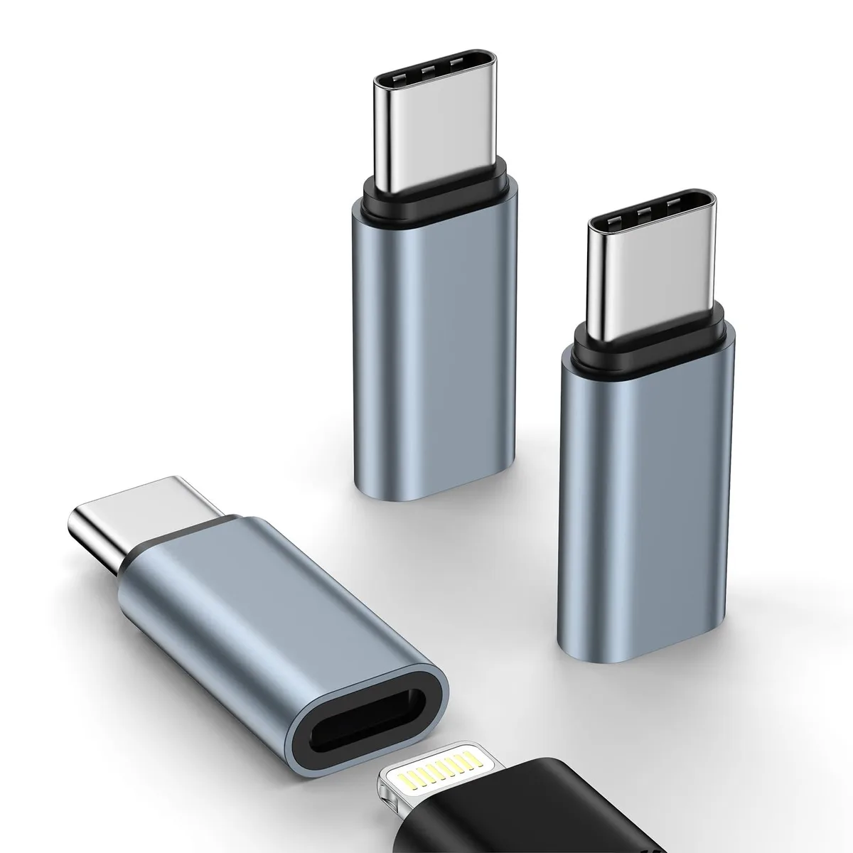 Three white Lightning to USB-C adapters side by side