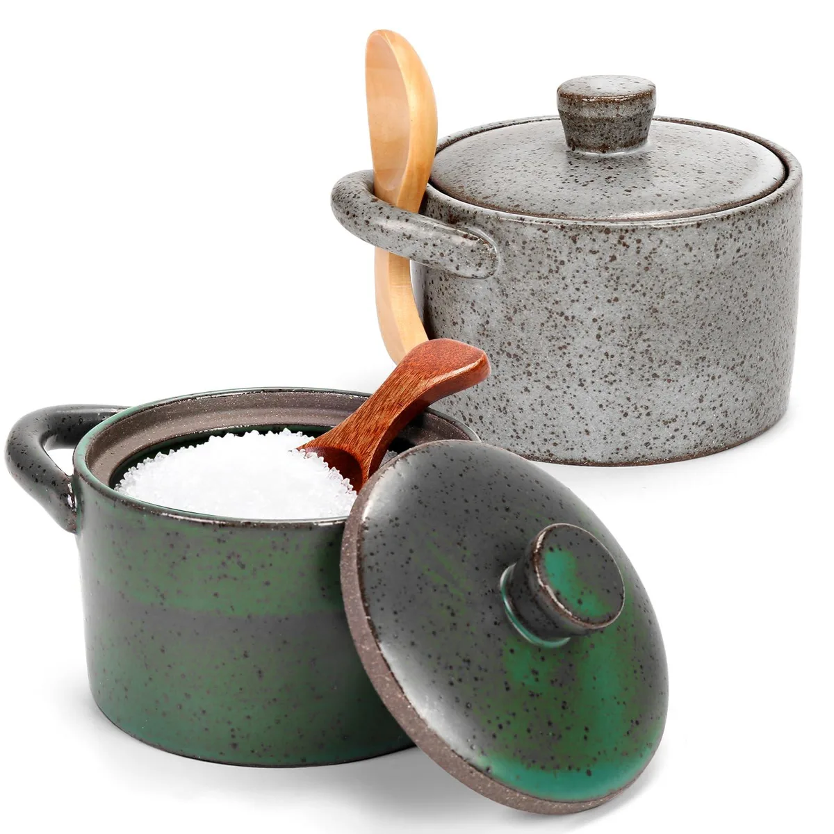 Two speckled ceramic salt cellars with lids and wooden spoons, gray and green finish