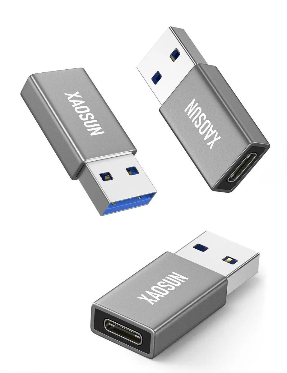 Three small gray USB-A to USB-C adapters with matte finish