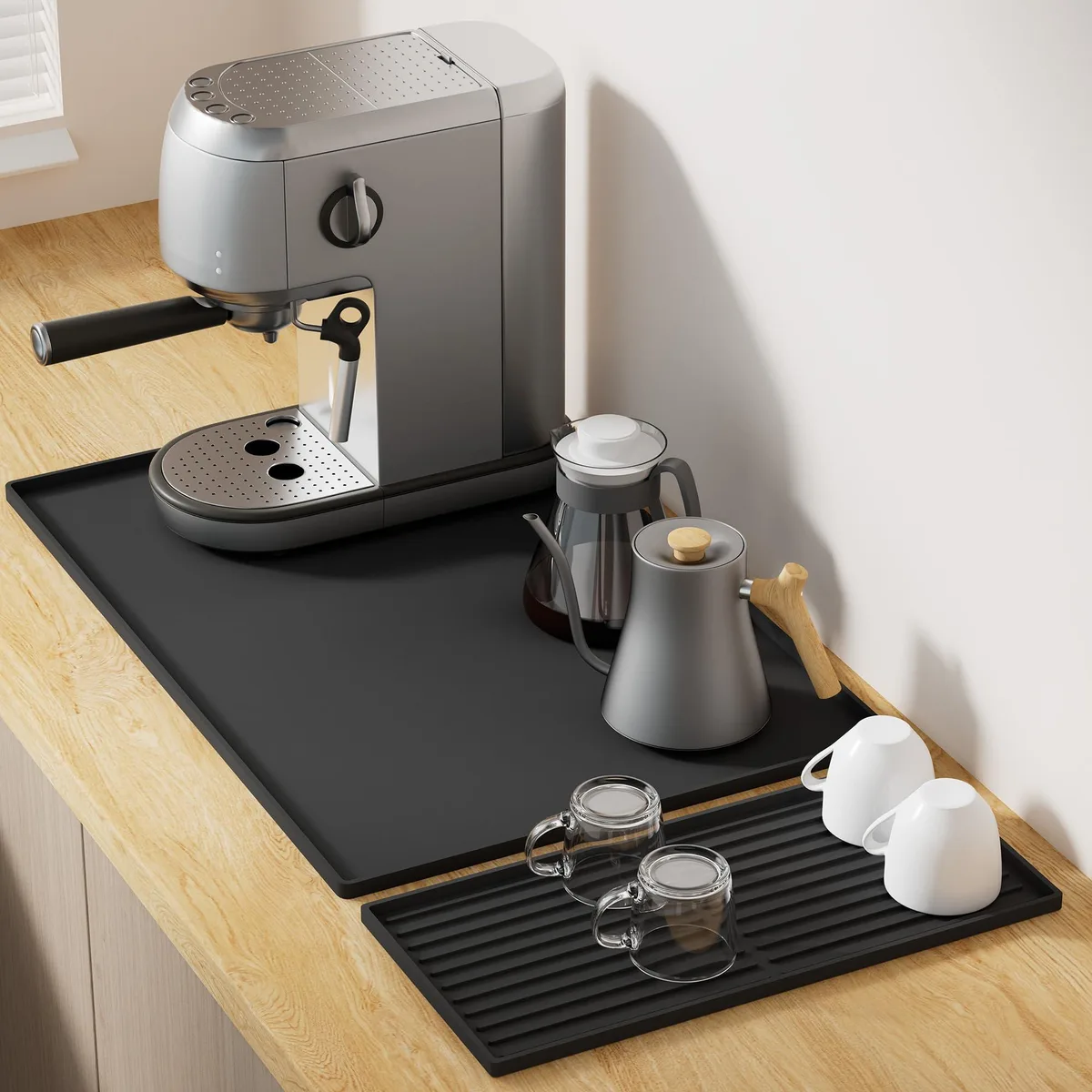 Two rectangular black silicone mats, 24 by 16 inches, silver finish, wavy stripe pattern