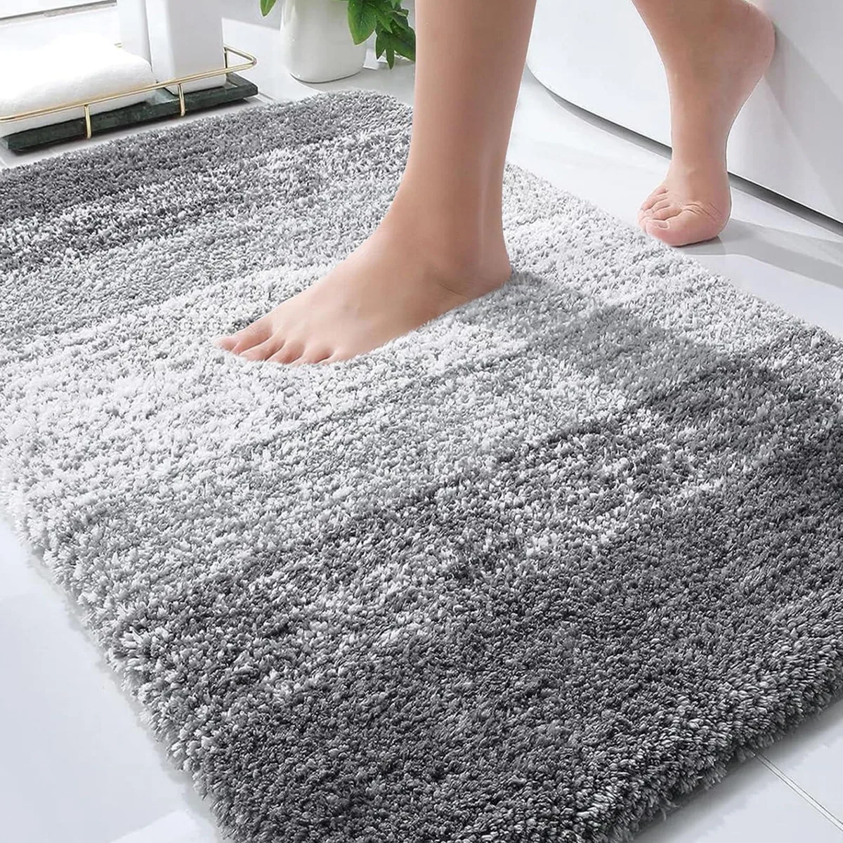 Grey rectangular microfiber bath mat with gradient stripe design, 30 by 20 inches, non-slip rubber backing