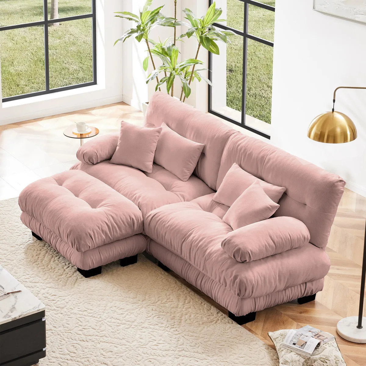 Pink chenille two-seater sectional with wide bolster arms, convertible ottoman and four pillows