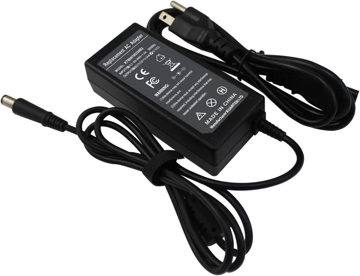 Black rectangular AC adapter with 7.4 by 5.0 mm barrel connector and three-prong plug