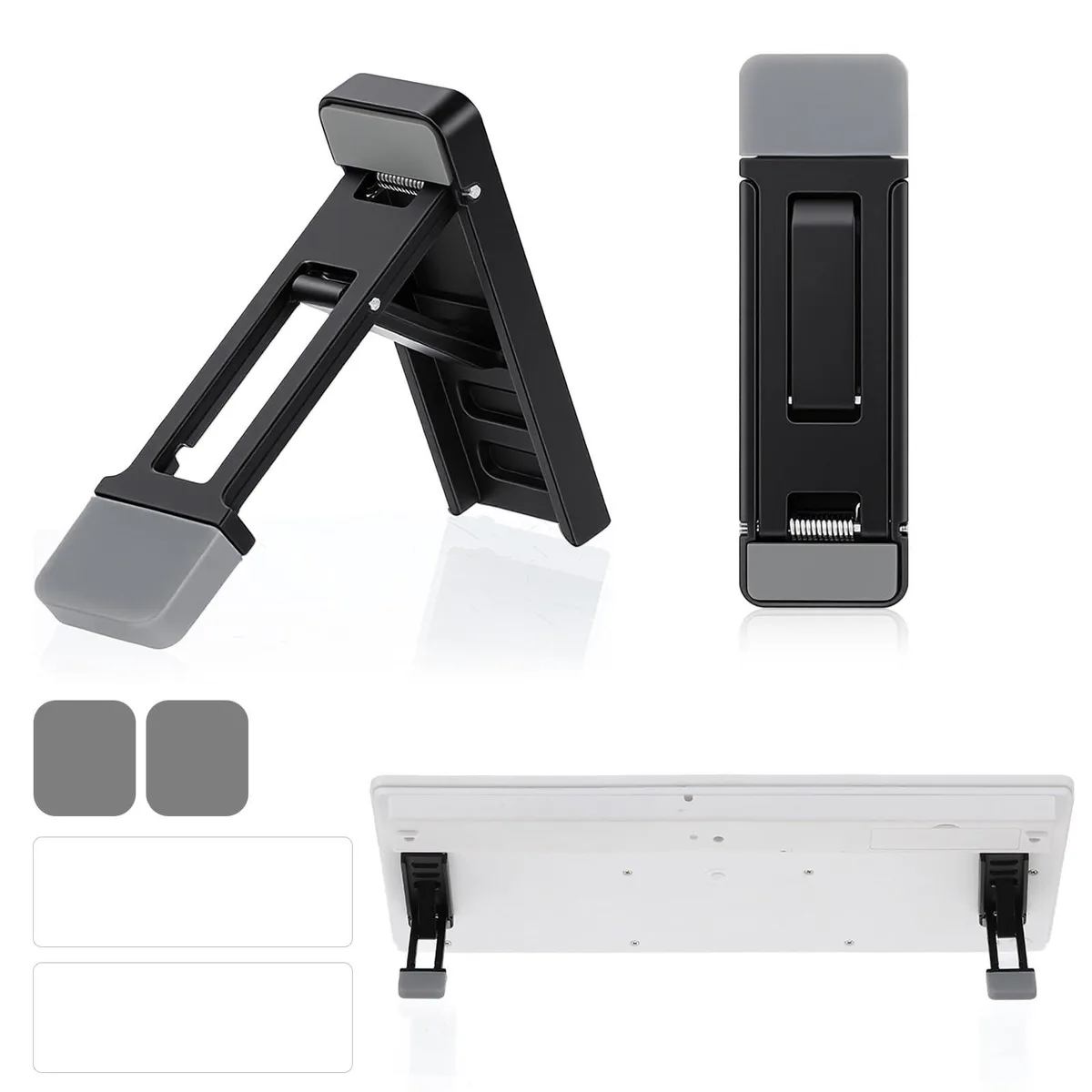 Two folded zinc-alloy and silicone keyboard risers with adhesive feet