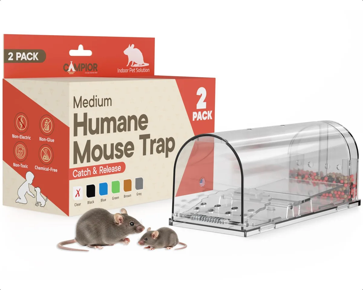 Two clear plastic mouse traps with spring doors and cleaning brush