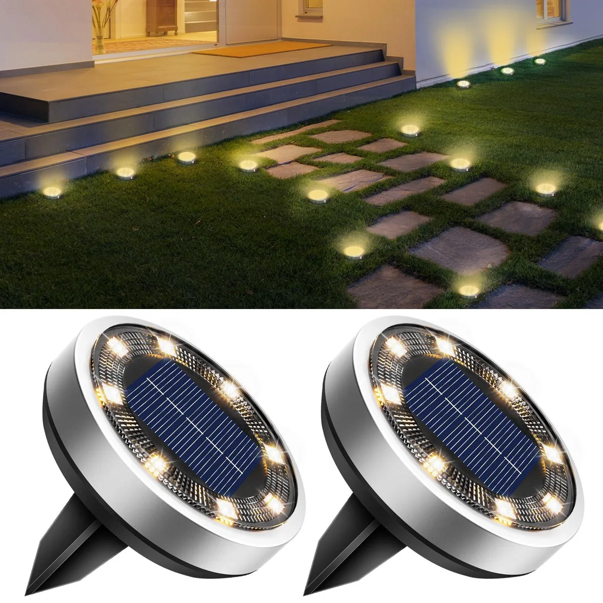 Two warm-white solar ground lights with stainless-steel tops and plastic bases, freestanding spike design