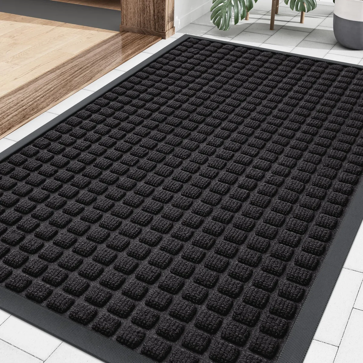 Black rectangular doormat with checkered pattern, low-profile rubber backing, 29.5 by 17 inches