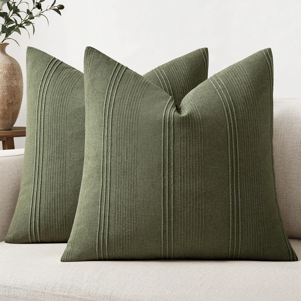 Two square olive-green pillow covers with vertical woven stripes, linen-blend texture, 20 inches each