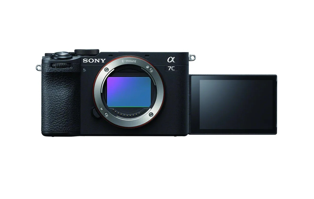 Compact black mirrorless camera body with textured grip and electronic viewfinder