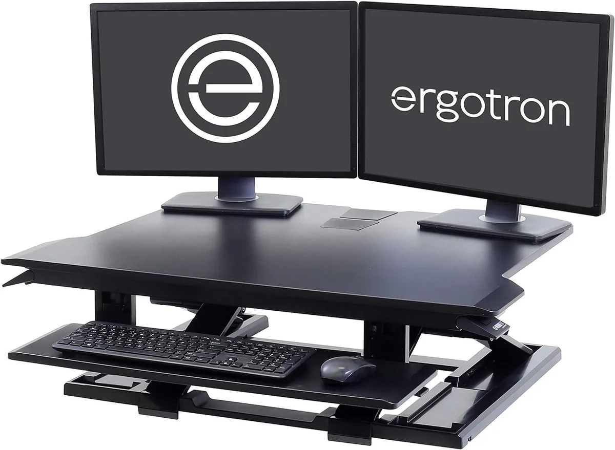 Black 32-inch standing desk converter with dual monitor surface and pull-out keyboard tray