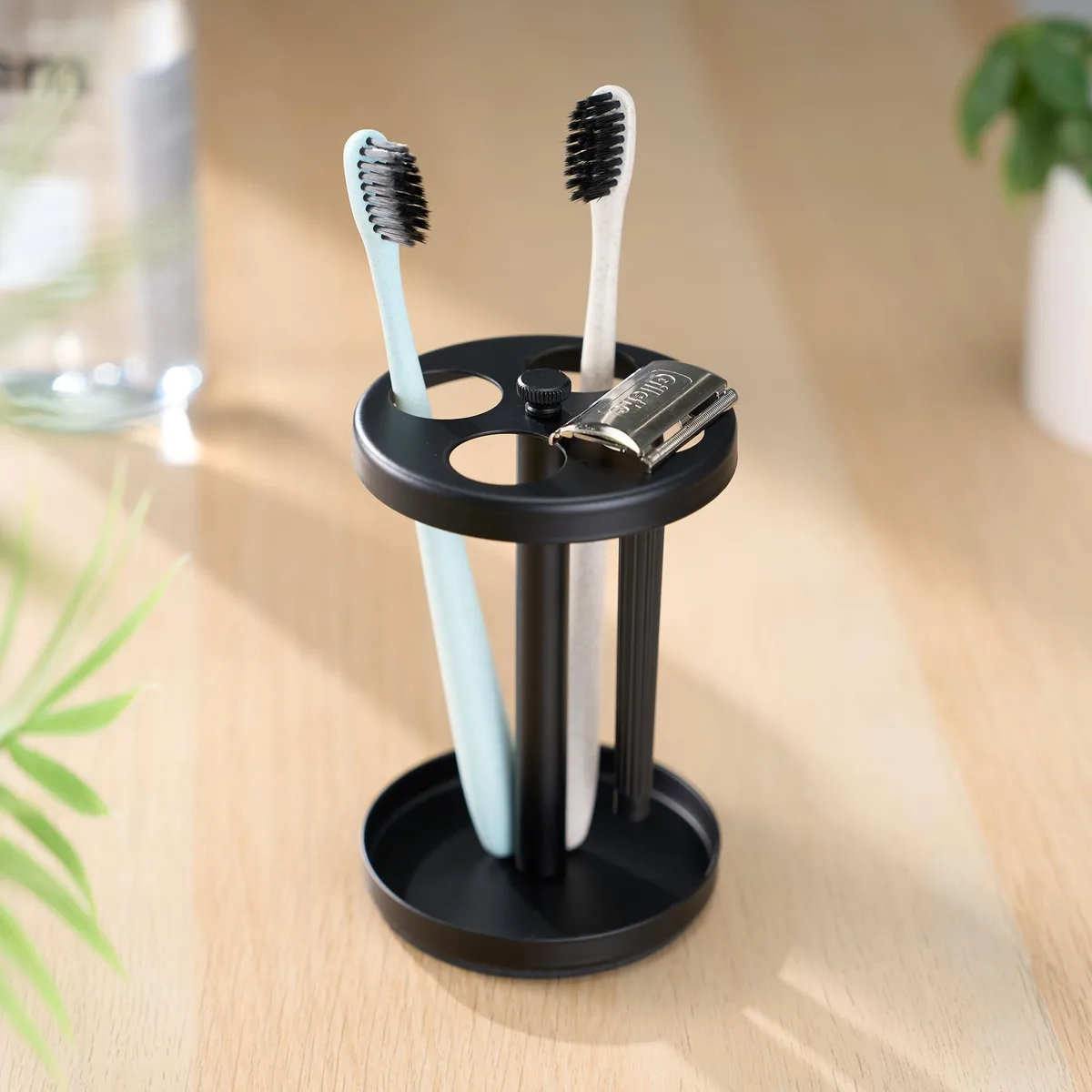 Compact black stainless steel toothbrush holder with four ventilated slots