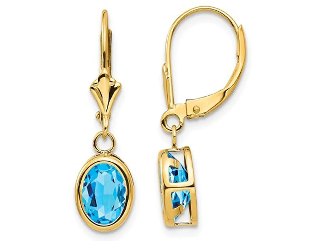 Pair of blue topaz dangle earrings on leverback hooks in yellow gold