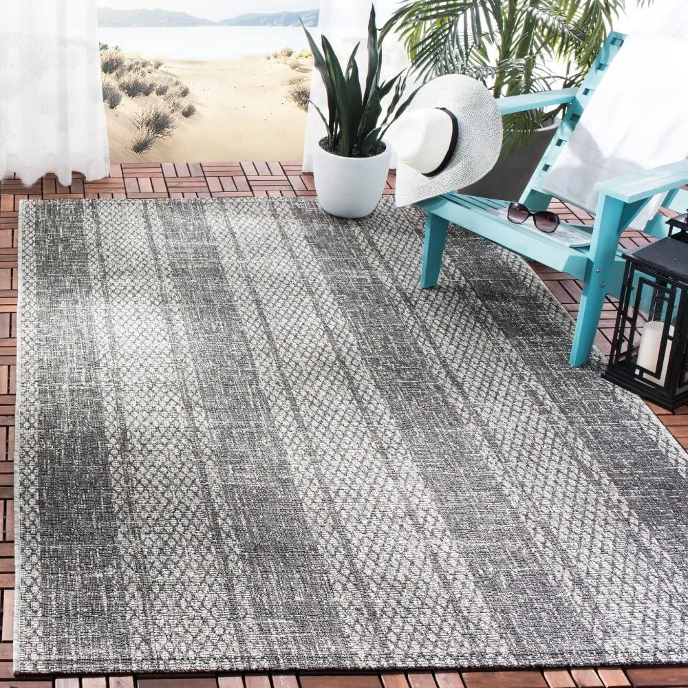 Rectangular light grey and black runner rug with low pile texture