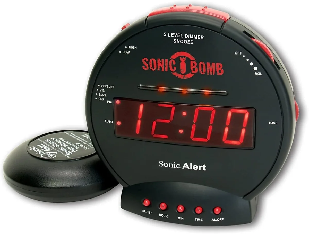 Rectangular digital alarm clock in black with red accents, bed shaker attached