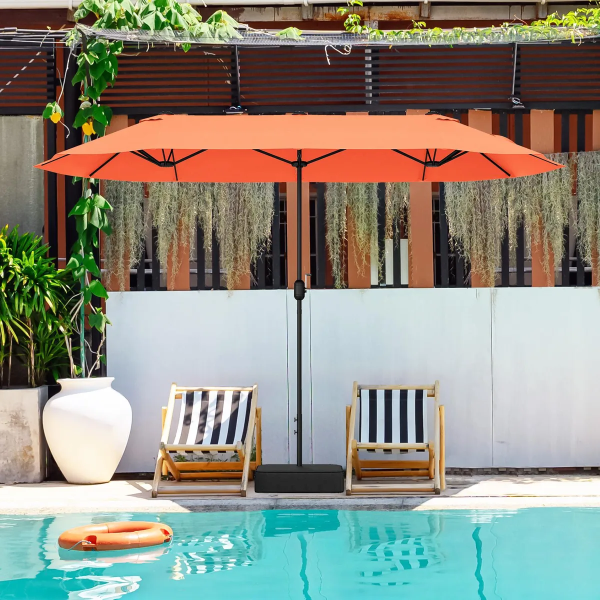 Large orange twin patio umbrella with crank handle and cross base