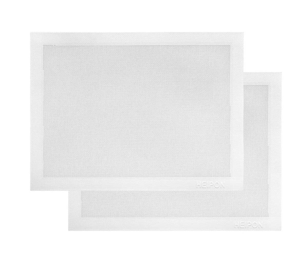 Two white perforated silicone baking mats with basketweave texture