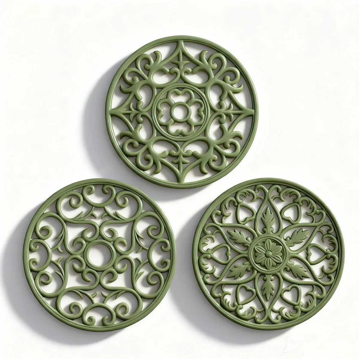 Three olive-green silicone trivet mats, 7.75in diameter, .25in thick, with carved patterns and hanging holes