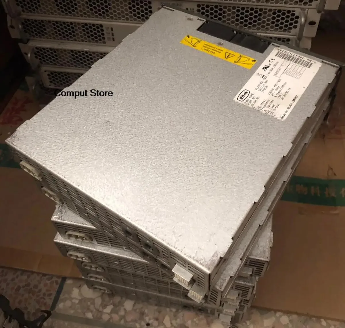 Rectangular silver power supply unit with front label showing 24V 50A 230Vac 1500W rating