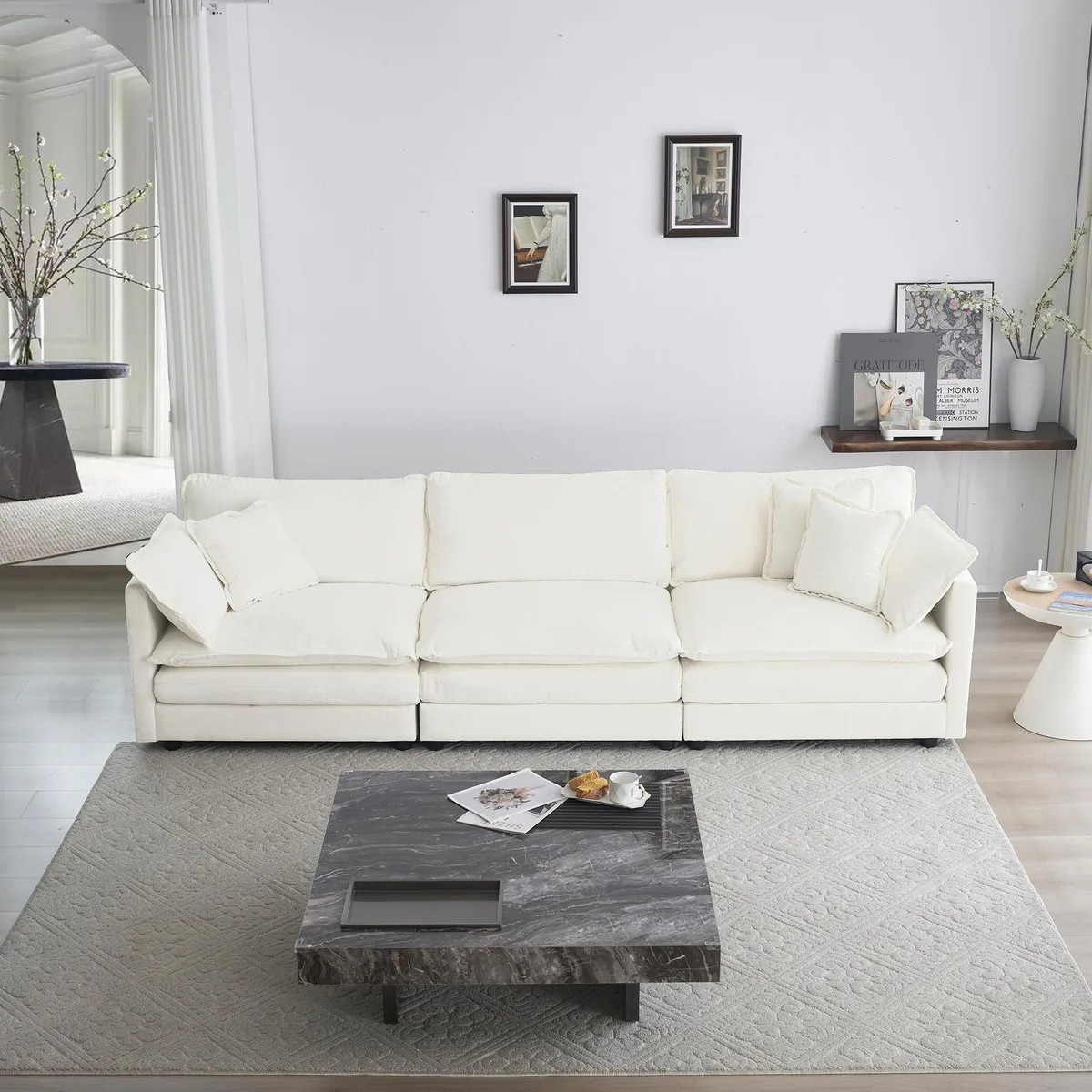 White chenille mid-century modern three-seater sofa with two armrest pillows and three toss pillows