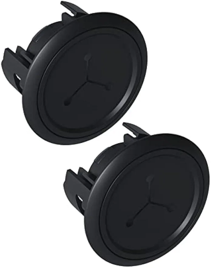 Two black plastic in-wall cable grommets with winged locking tabs and snap-on covers