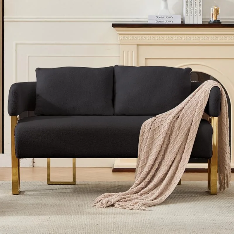 Black teddy-upholstered armchair with gold metal legs