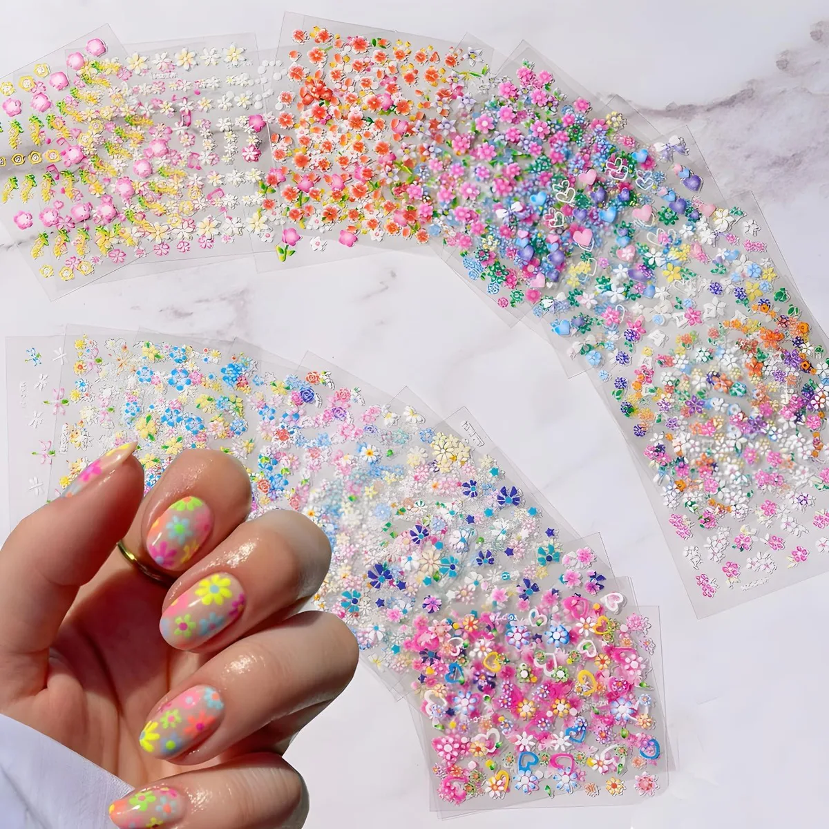 Thirty sheets of colourful 3D floral and heart nail stickers on backing cards