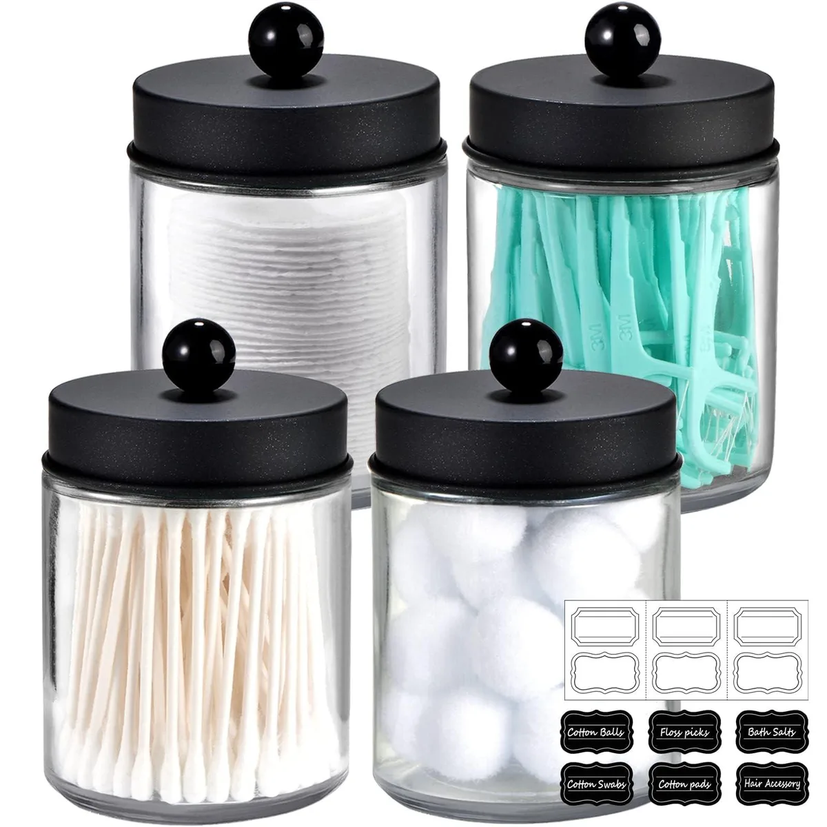 Four clear glass apothecary jars with stainless steel lids