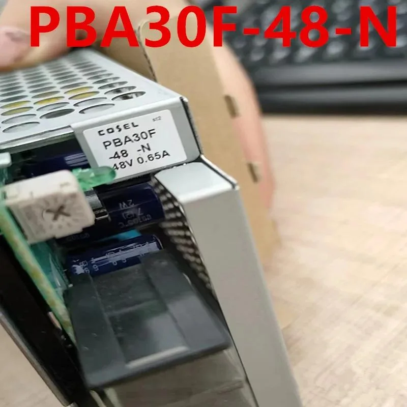 Rectangular black ATX power supply unit with cooling fan and cable connections