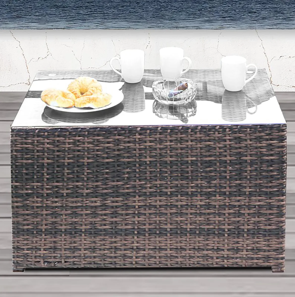 Rectangular brown wicker coffee table with glass top 33 by 22 by 18 inches