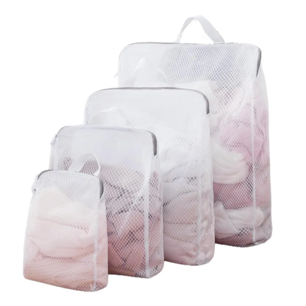 Four beige mesh laundry bags with zips and hanging handles, sizes small to extra large