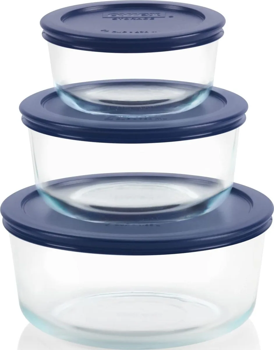 Three clear glass round containers with navy blue lids in 2, 4 and 7 cup sizes
