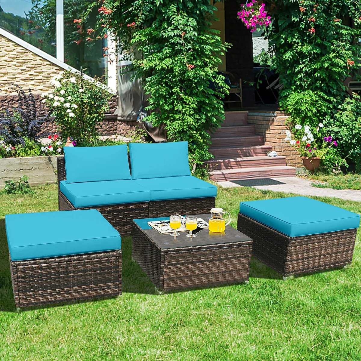 Five-piece turquoise rattan wicker patio sofa set with cushions and glass-top table