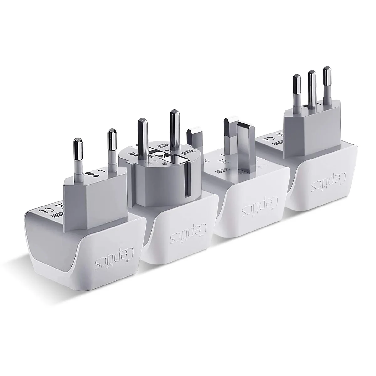 Four white travel plug adapters with different European pin types